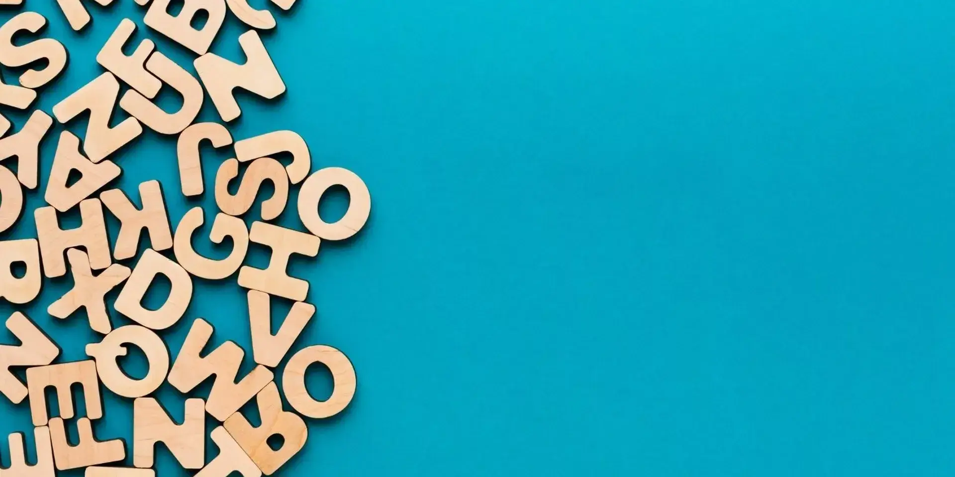 jumbled wooden letters scrawled out against a blue background