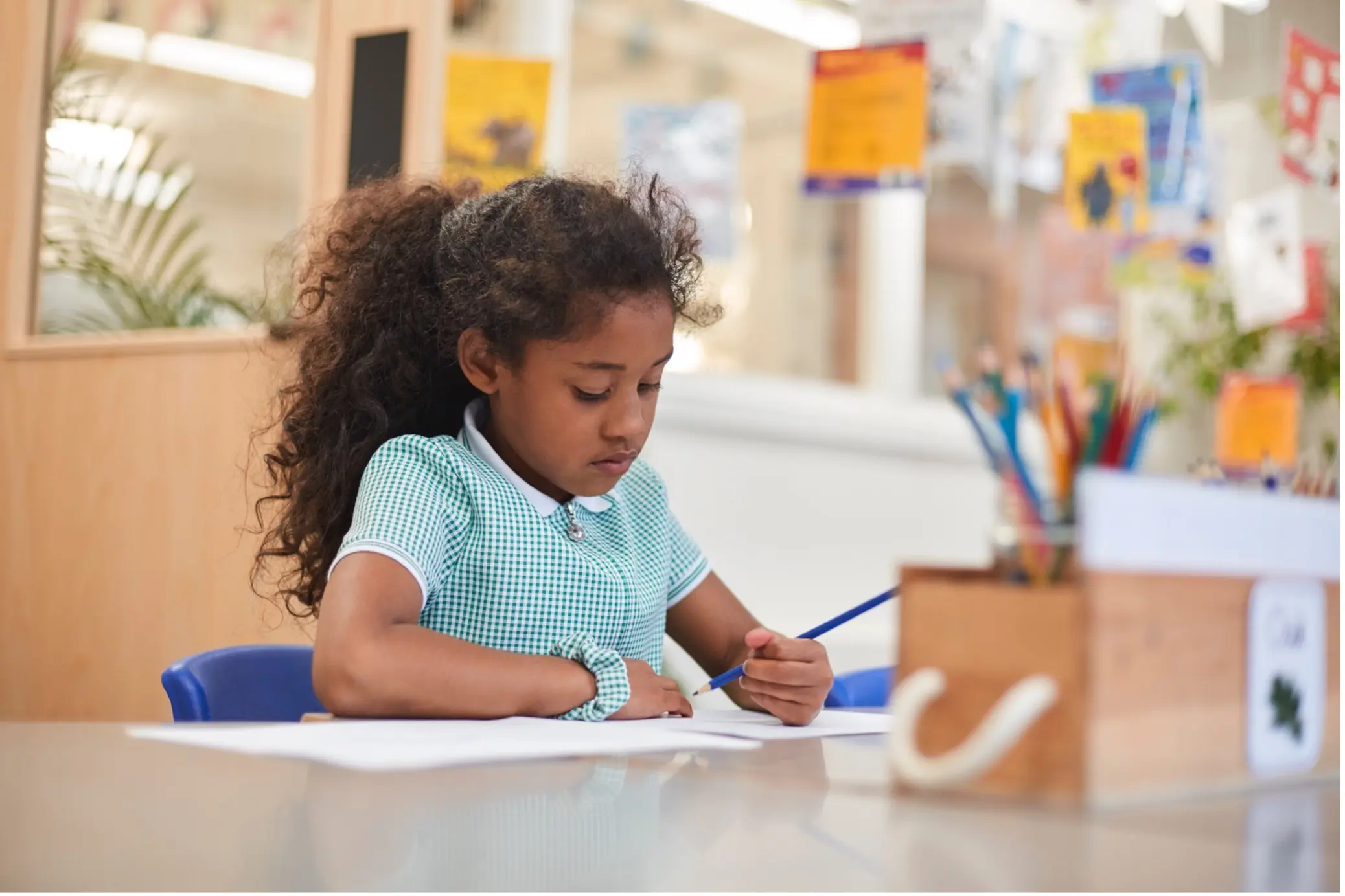 a school child sat at a desk writing