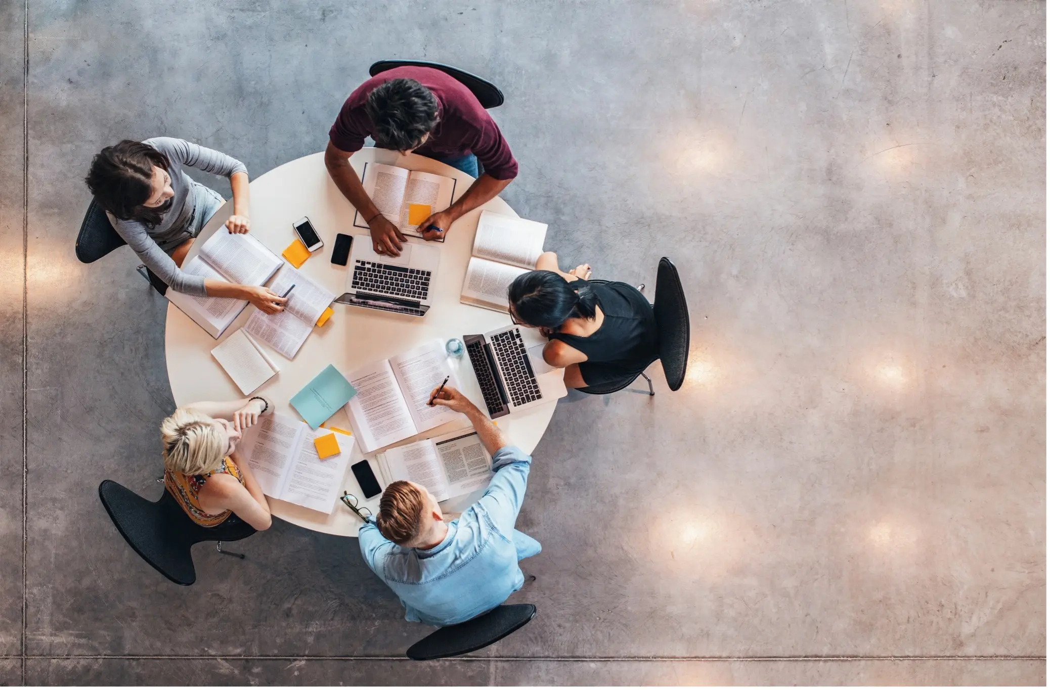 a group of college students studying around a table