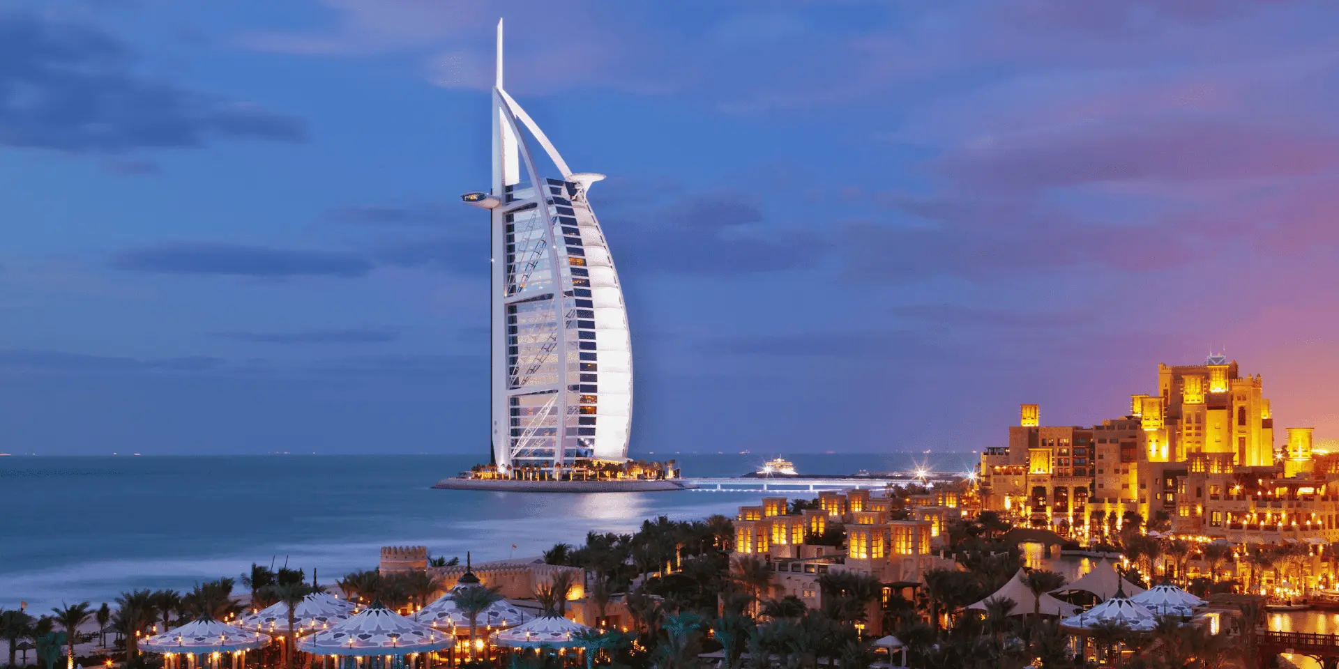 the skyline of dubai with the burj al arab prominently on the shoreline