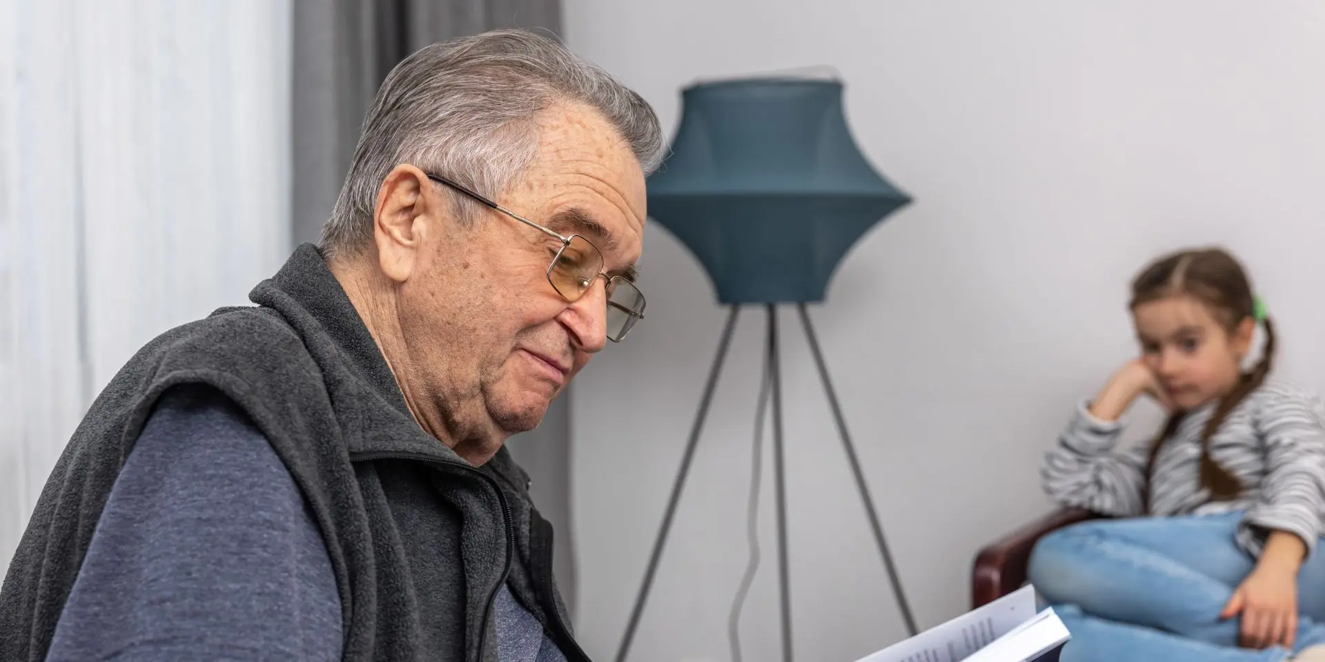 Old man reading to girl