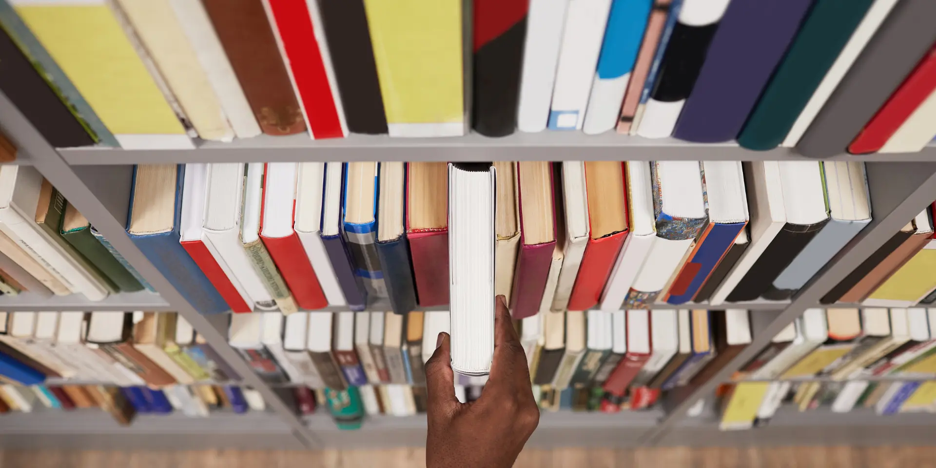 Student Taking Book in Library Closeup