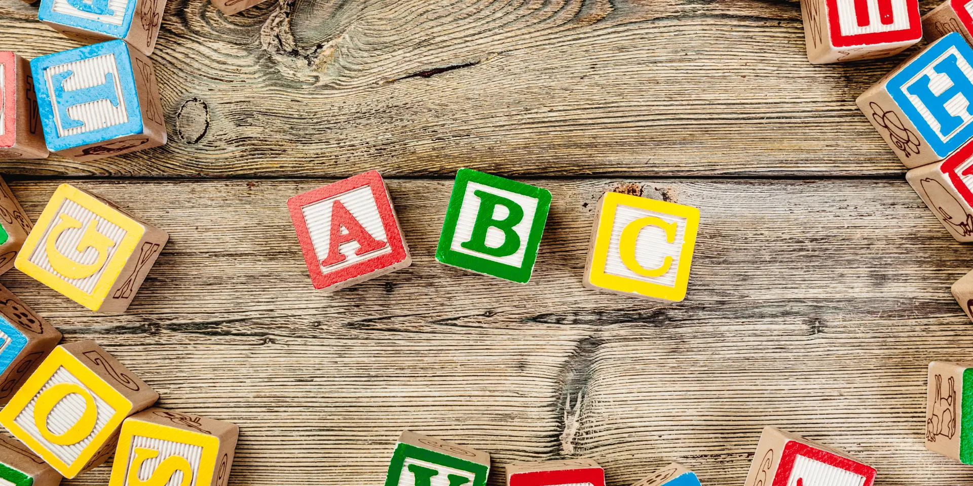 Letters background Wooden cubes with letters on wooden background