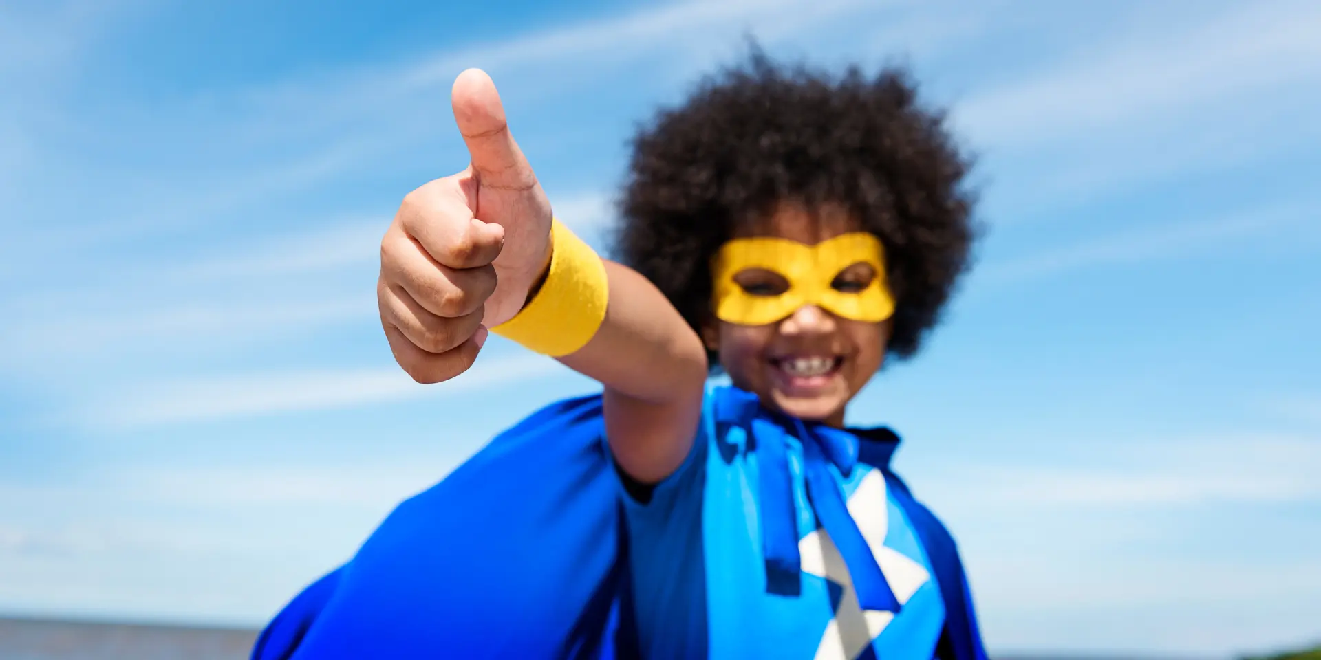 Cute little superhero girl with afro