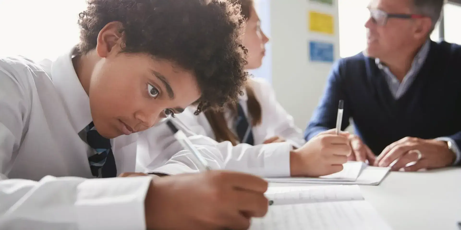 young boy focusing on literacy school work