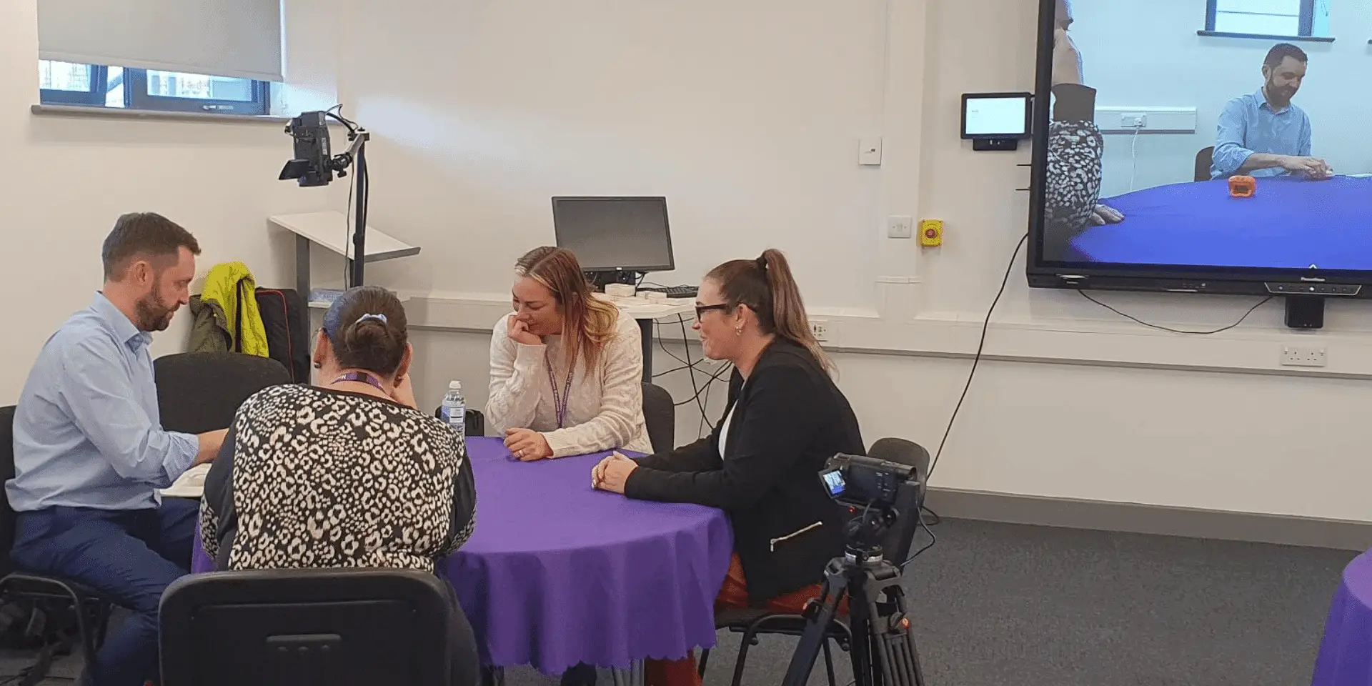 a lexonik trainer and teachers sat around a table at a lexonik leap training event