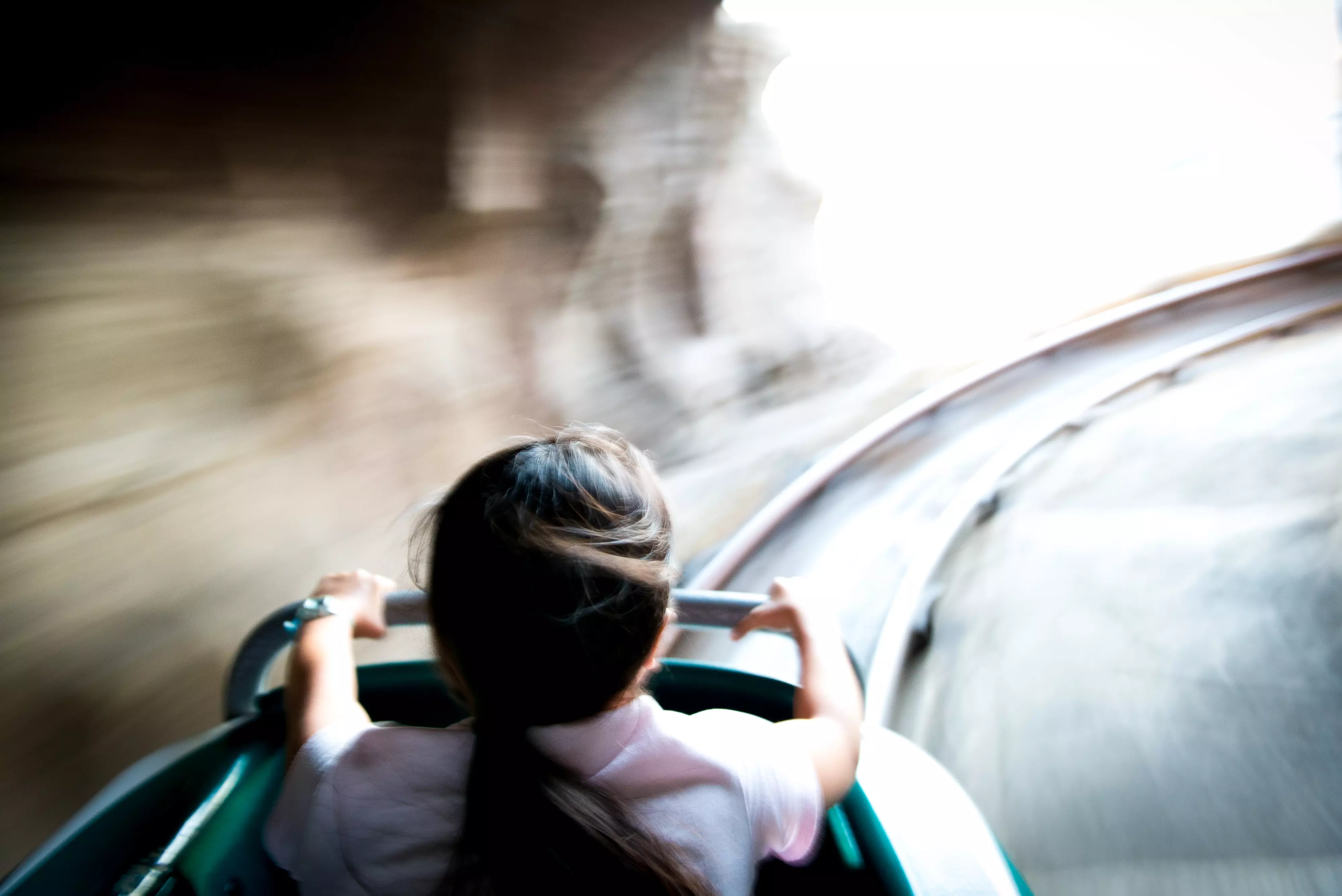 Girl on a rollercoaster moving at high speed