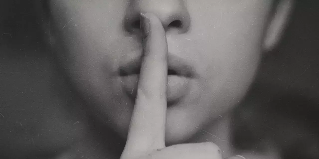 a person with his finger on his lip making the shush gesture